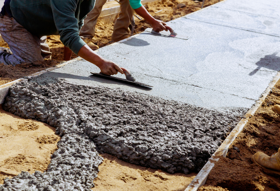 workers leveling concrete sidewalk